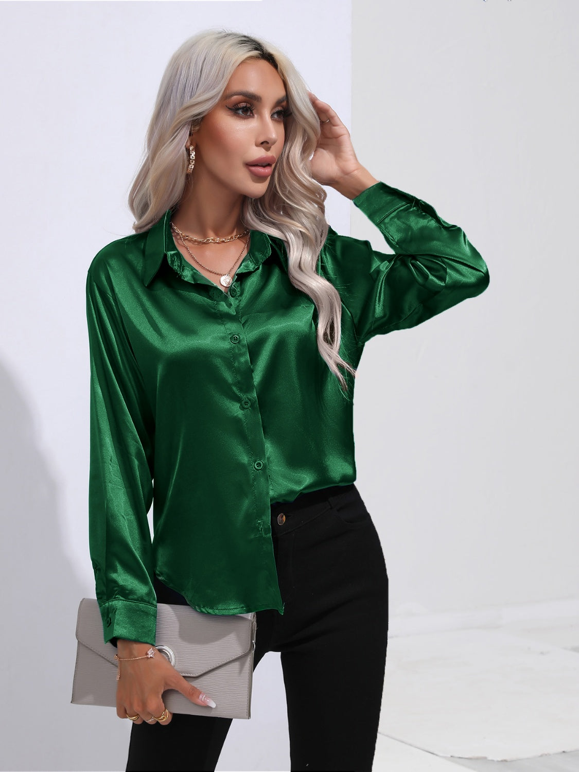 Dark green satin tie-front blouse with buttoned front and collar.