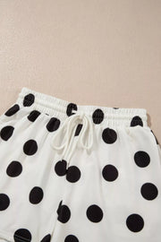 White polka dot lounge shorts with drawstring waist and elastic band.