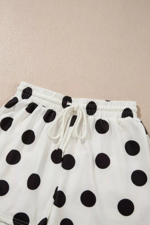 White polka dot lounge shorts with drawstring waist and elastic band.