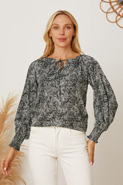 Black serpentine print blouse with tie neck and gathered sleeves