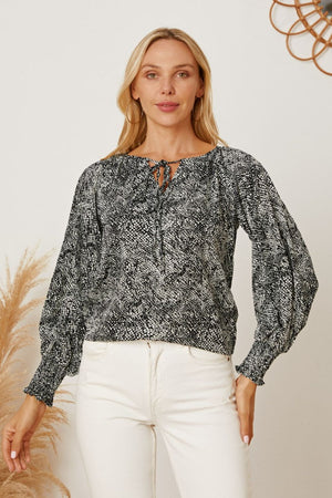 Black serpentine print blouse with tie neck and gathered sleeves