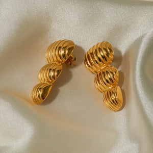 Gold drop earrings with sculptural spiral design, 18K gold-plated.