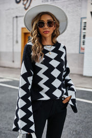Black chevron knit sweater with bell sleeves and a crew neck.