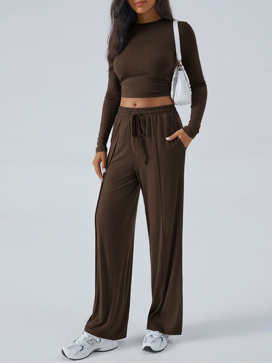 Ribbed knit crop top and wide leg pants set in coffee brown, with drawstring waist and side slits.
