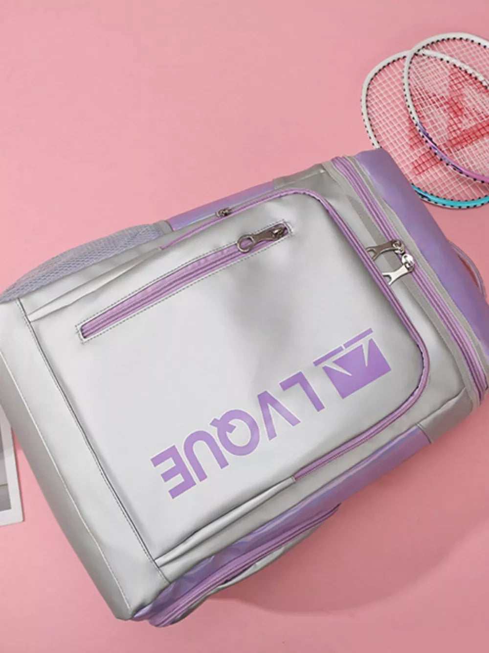 Iridescent silver waterproof sports backpack with purple accents and logo, showing racket compartment.