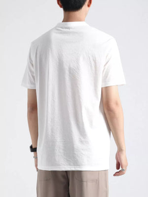 Men's white buttoned henley t-shirt with band collar and short sleeves.