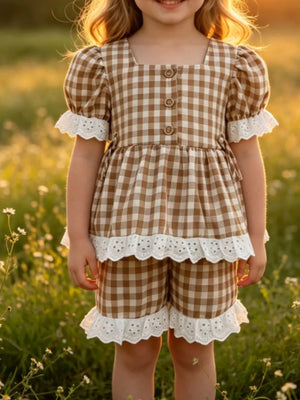 Gingham baby set with square neck, puff sleeves, and eyelet ruffle trim.