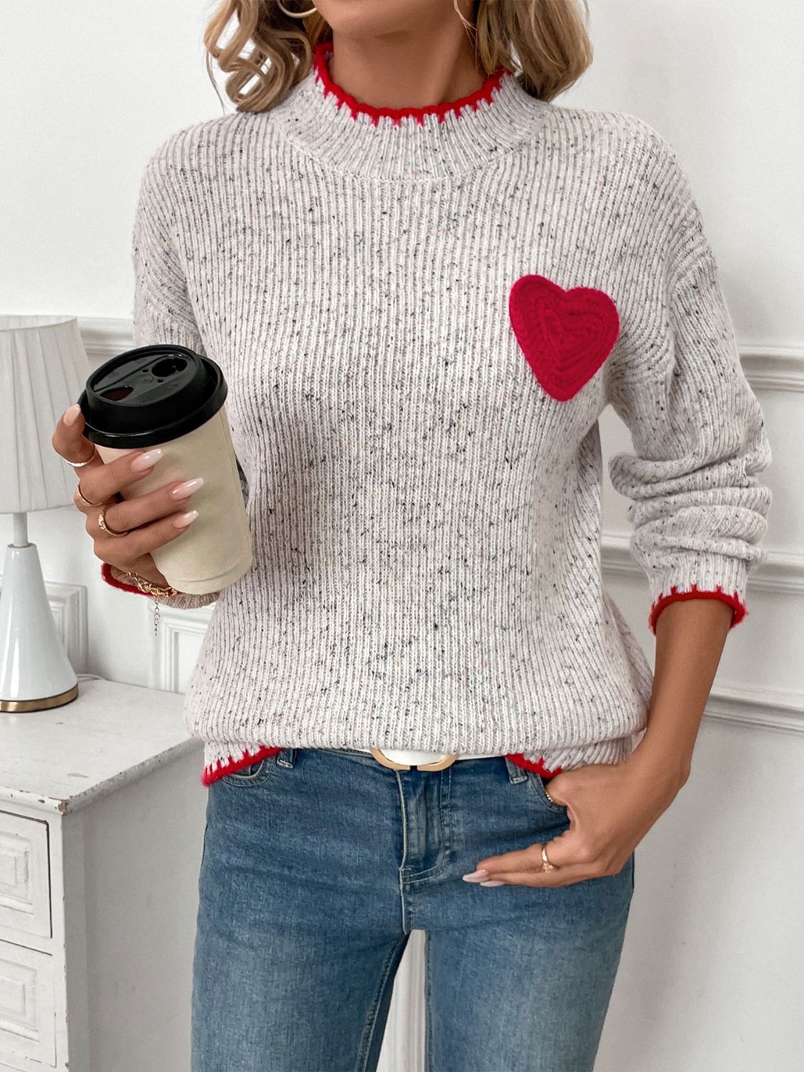 Light gray ribbed knit sweater with red heart appliqué and contrast trim.