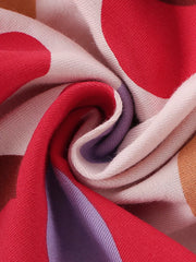 Toddler dress fabric detail with red, purple, and tan polka dots and stripes on cotton.
