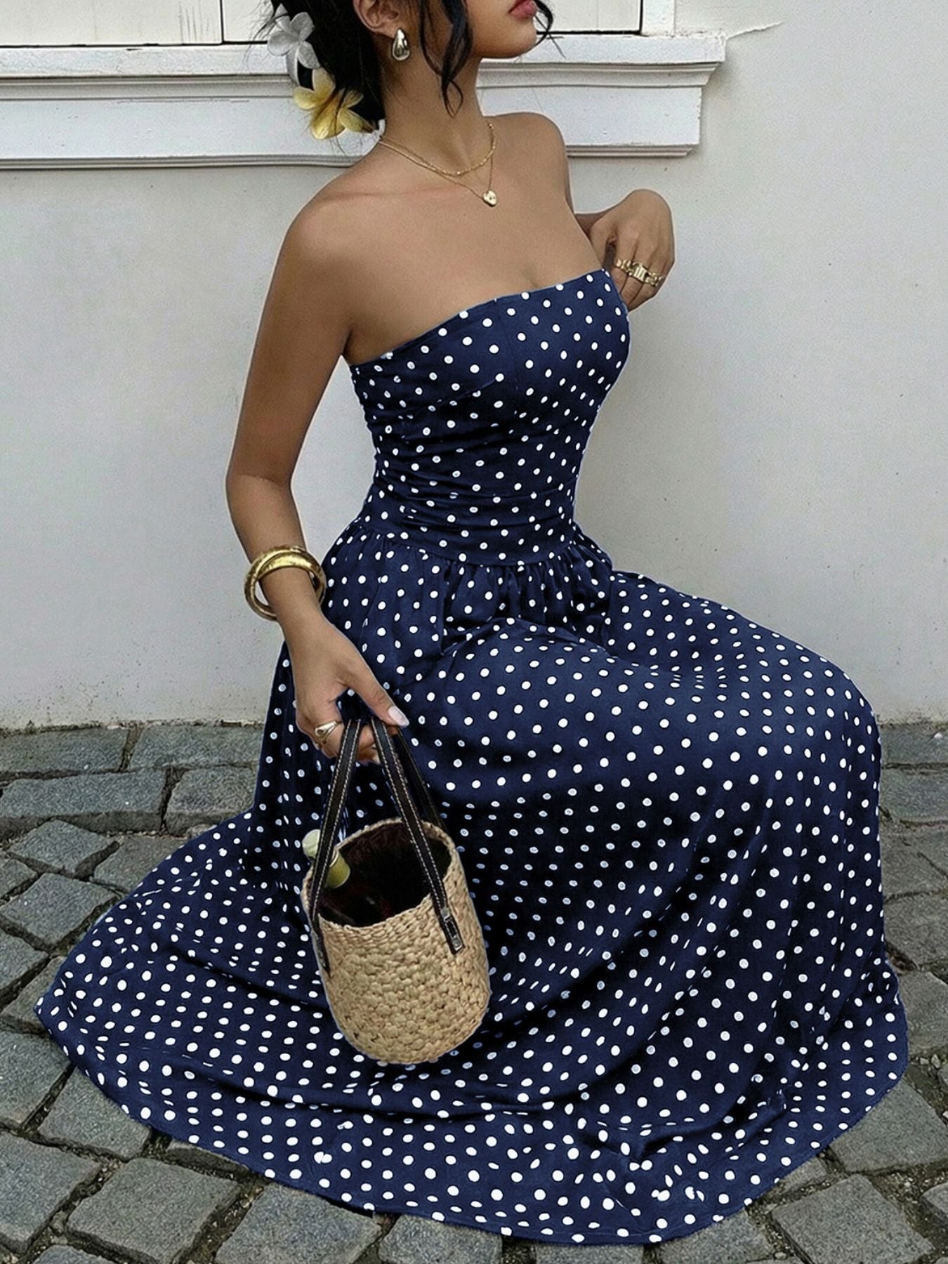 Navy polka dot A-line maxi dress with sweetheart neckline and cinched waist detail.