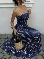 Navy polka dot A-line maxi dress with sweetheart neckline and cinched waist detail.