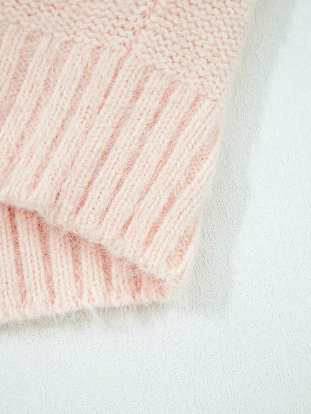 Pink acrylic knit sweater with ribbed texture detail