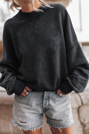 Acid wash mock neck sweatshirt in black with ribbed cuffs and neckline.