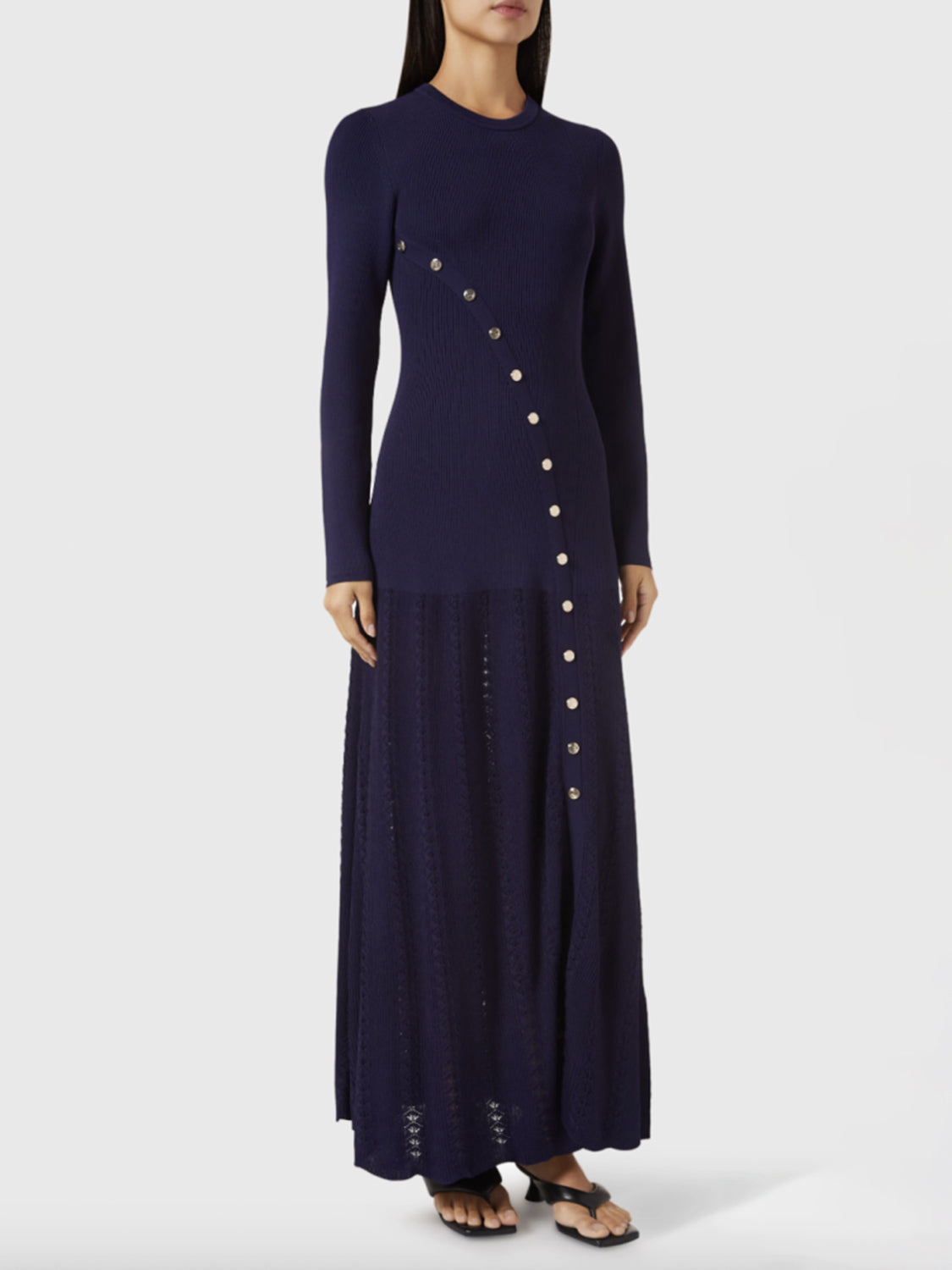 Dark blue ribbed knit maxi dress with decorative buttons and textured skirt.