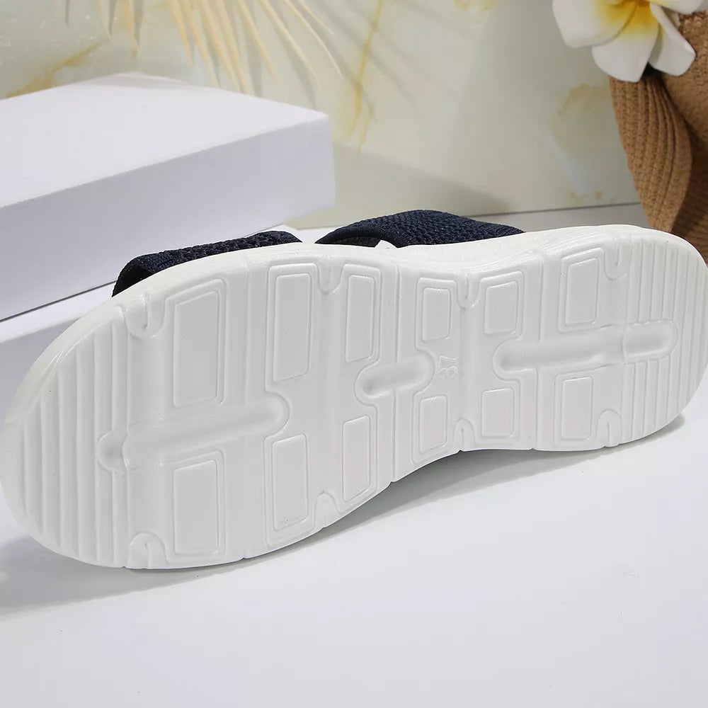 Dark blue mesh sandals with a white sole and textured tread.