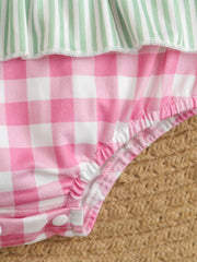 Baby one-piece swimsuit with pink gingham and green stripe ruffle detail.