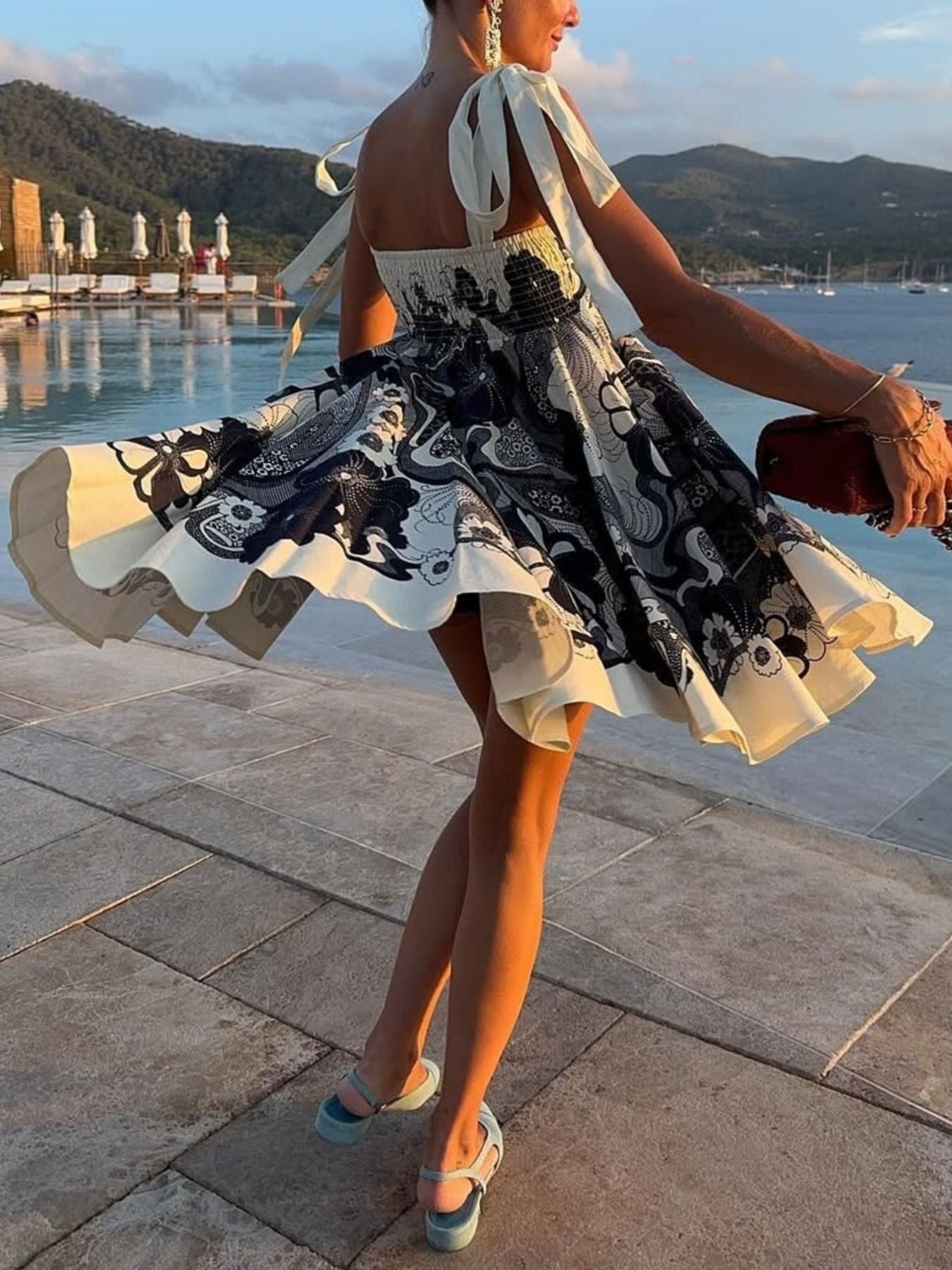 Black floral tie-strap mini dress with smocked bodice and ruffled hem