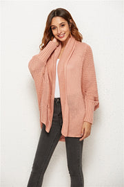 Textured cocoon knit cardigan in blush pink with batwing sleeves and open front.