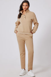 Button-neck lounge set in dust storm beige with snap closure and relaxed fit pants.