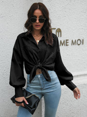 Black poplin button-down blouse with balloon sleeves tied at the waist.