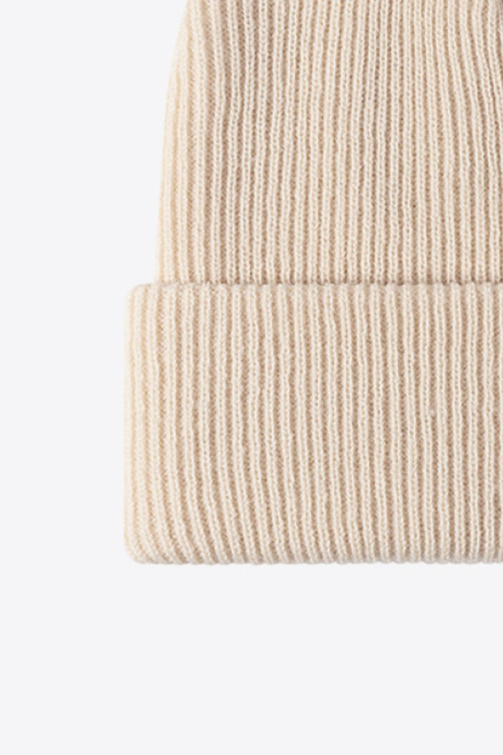 Beige ribbed knit beanie with a cuffed hem