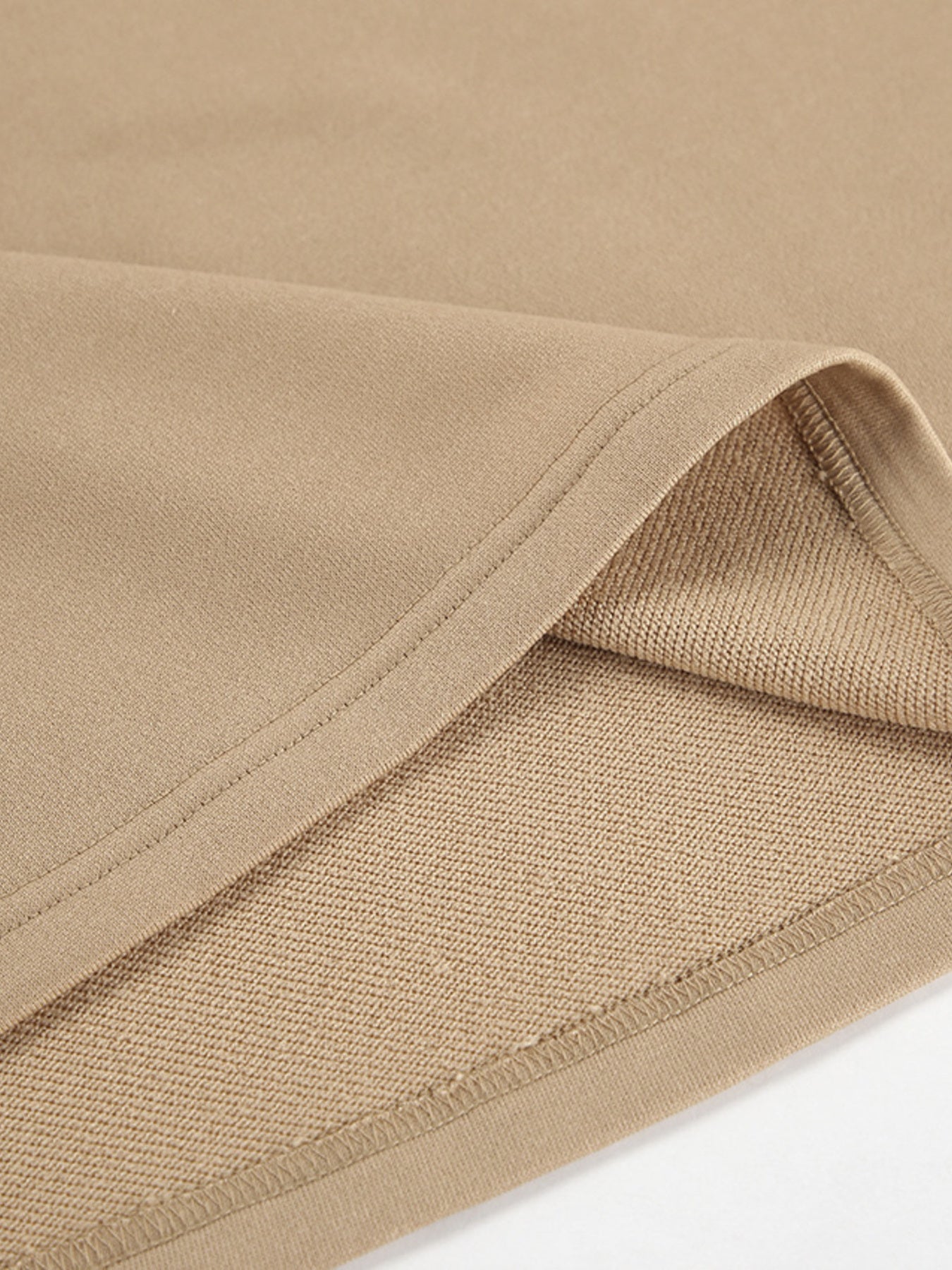 Camel quarter zip top and pants set detail showing soft fabric and stitching.