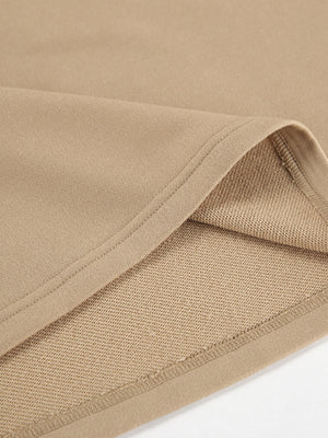 Camel quarter zip top and pants set detail showing soft fabric and stitching.