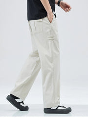 Beige casual straight leg trousers with a loose fit and buttoned back pocket.