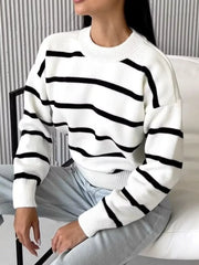 Classic white knit sweater with black stripes and round neck.