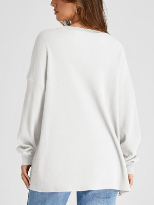 White waffle knit raglan sleeve sweatshirt with crew neck and relaxed fit.