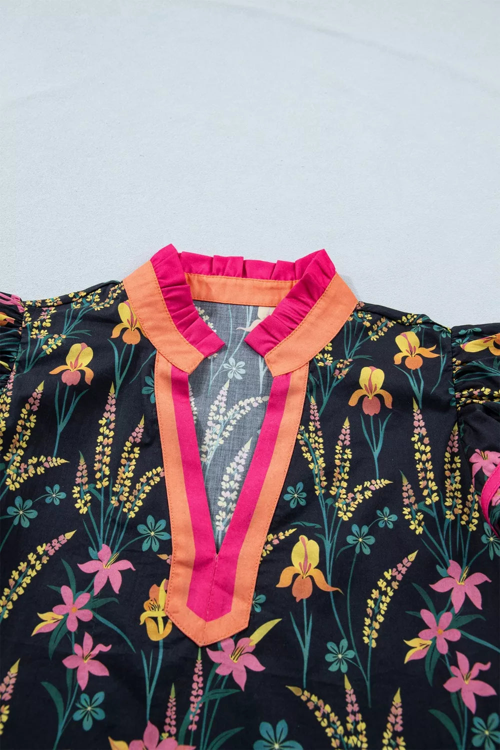 Vibrant floral print cotton blouse with contrast trim and ruffled collar