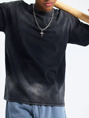 Men's oversized vintage wash t-shirt in black with paint splatter detail and crewneck.