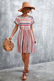 Striped trapeze dress with yoke seam and short sleeves in coral and white stripes.