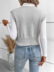 Gray knit vest with ribbed trim and button detail, layered over a white turtleneck.