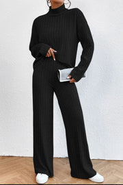 Black ribbed knit turtleneck lounge set with wide leg pants.
