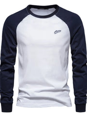 White long sleeve raglan tee with navy sleeves and a small embroidered logo.