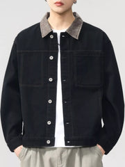 Black cotton jacket with contrasting collar and button front, featuring chest pockets.