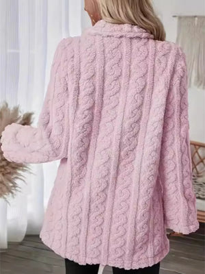 Pink faux shearling overcoat with cable knit texture and shawl collar.
