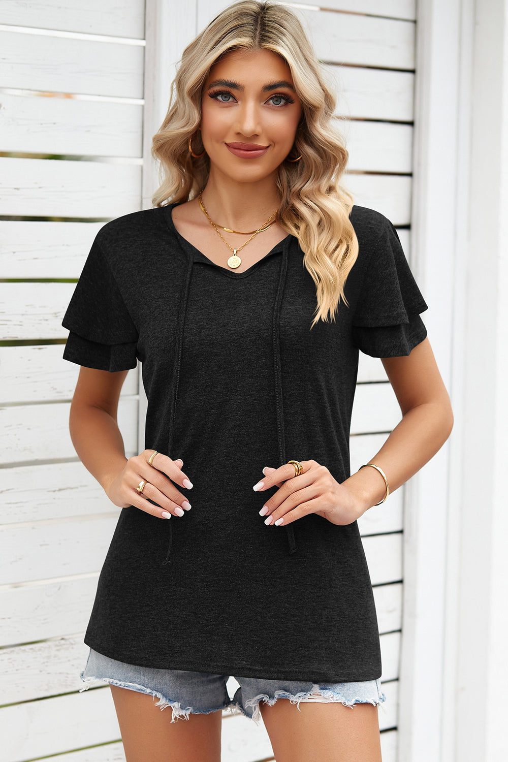 Black flutter sleeve henley tee with tie neck and layered sleeves.