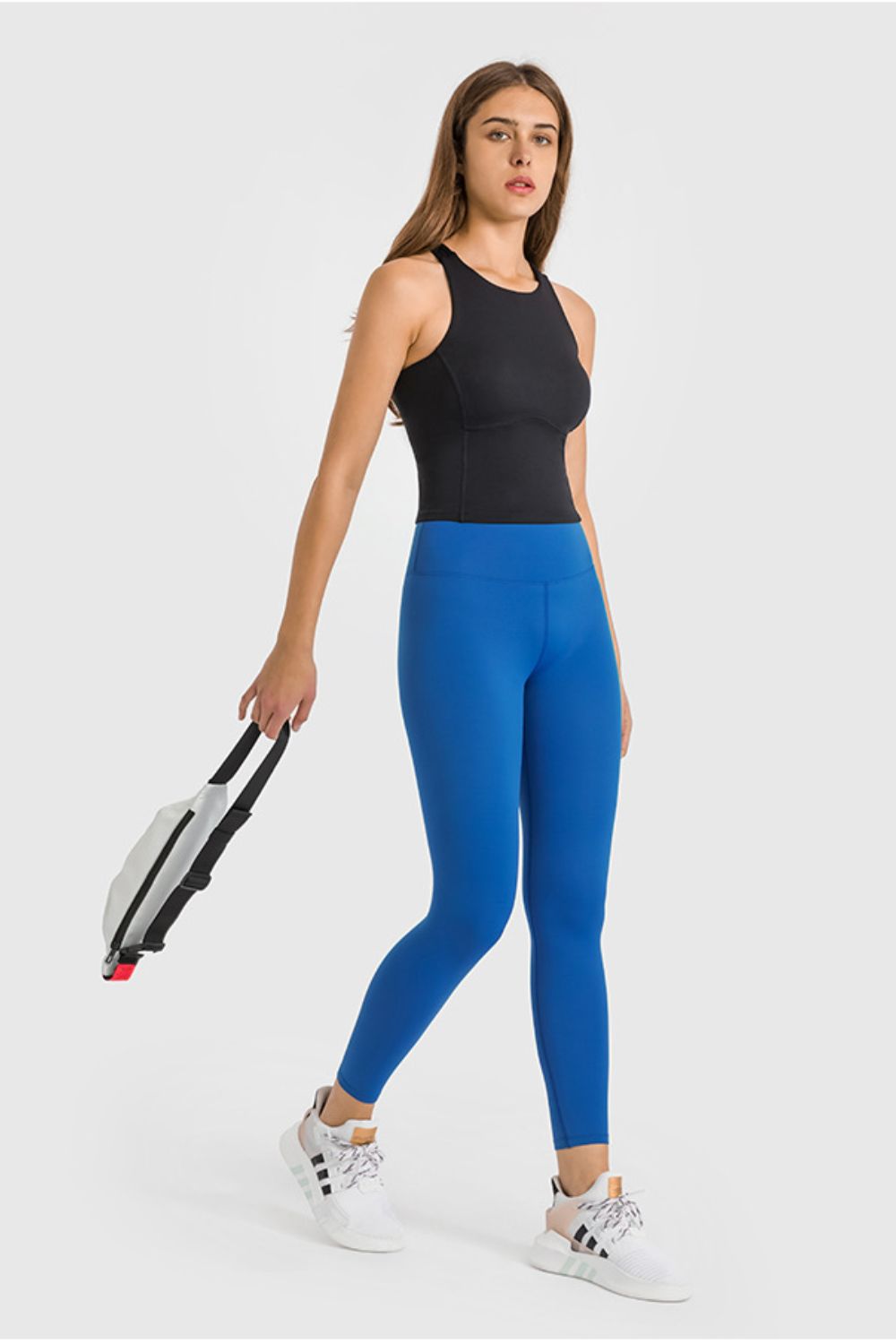 Sculpted high-waist performance leggings in bright blue, ankle length, with a black tank top.