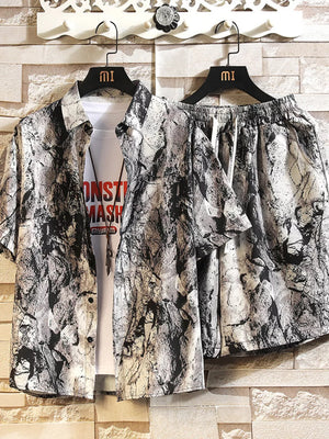 Men's abstract print short-sleeve shirt and shorts set in dark gray, white, and black with drawstring shorts.