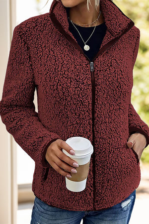 Burgundy teddy fleece zip-up jacket with a stand collar and pockets.