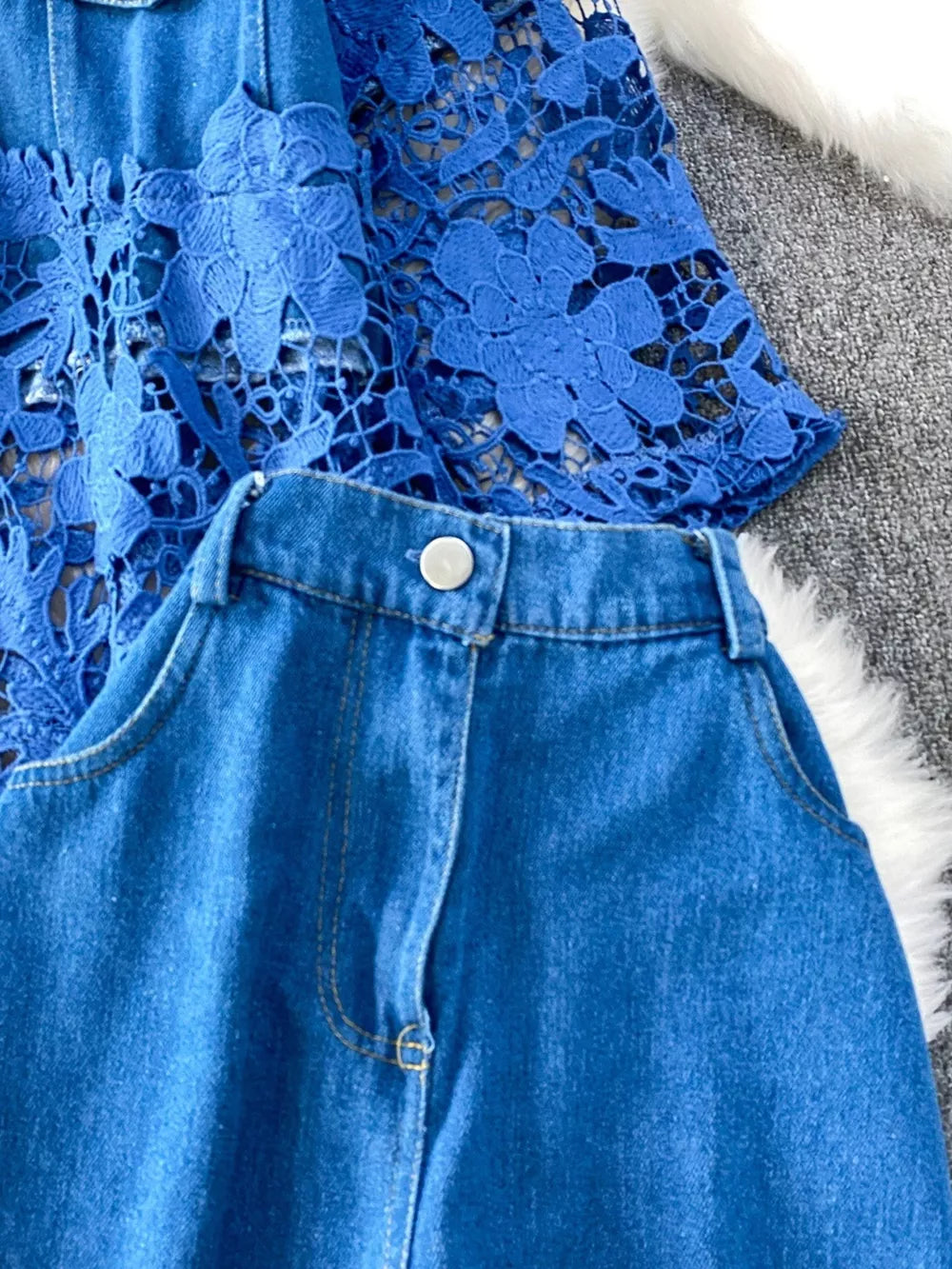 Blue lace-embellished two-piece set with denim shorts and a detailed top.