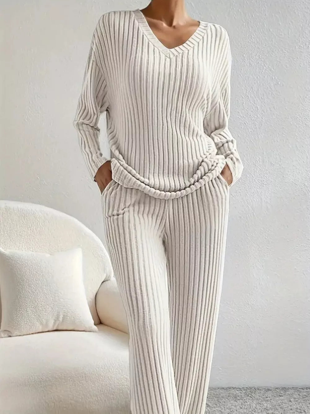 Ribbed knit loungewear set in off-white with V-neck top and pants.