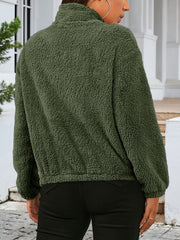 Green sherpa bomber jacket with a stand-up collar and elastic cuffs.