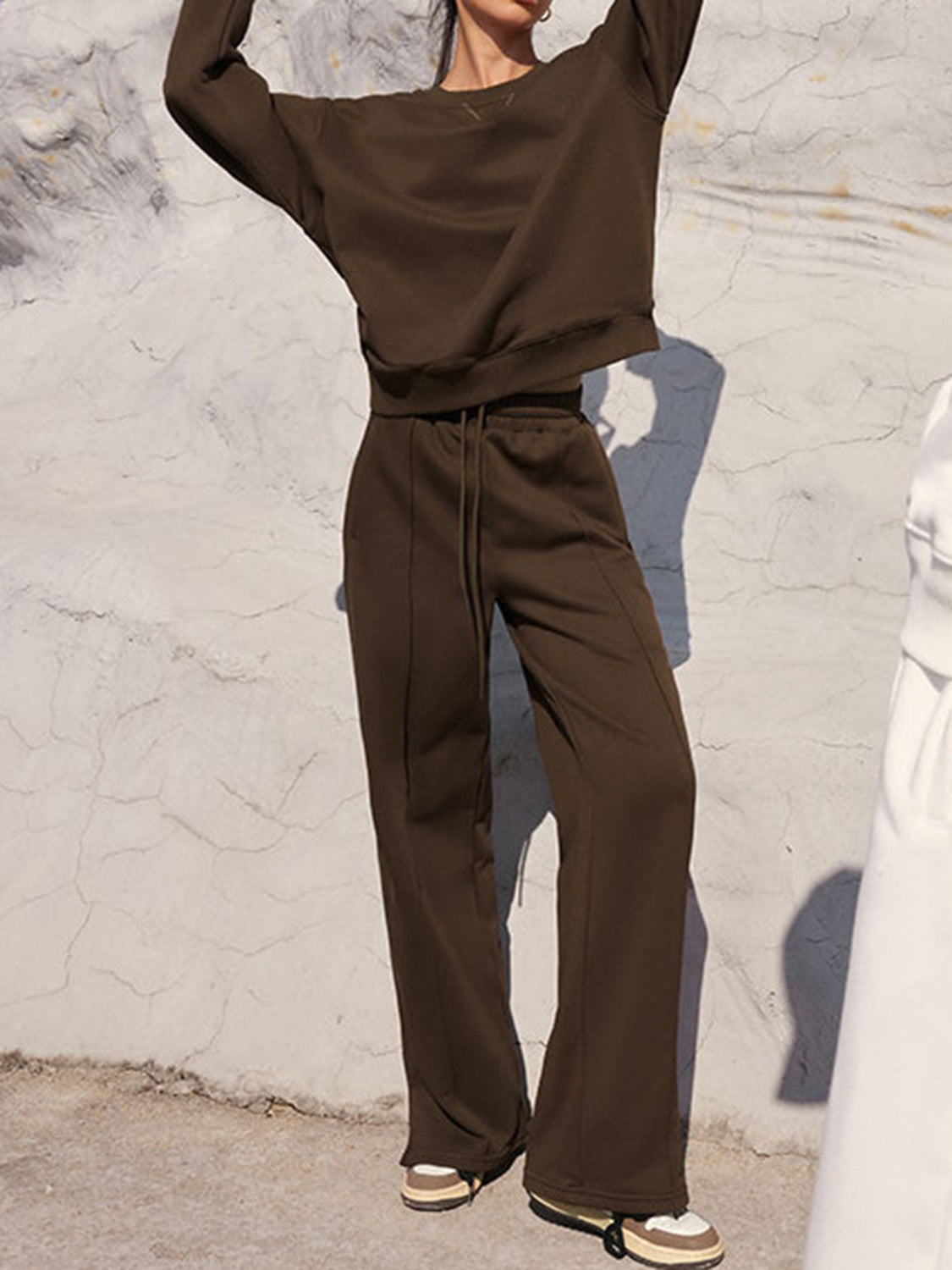 Brown seamed sweatshirt and wide-leg lounge pants set with drawstring waist.