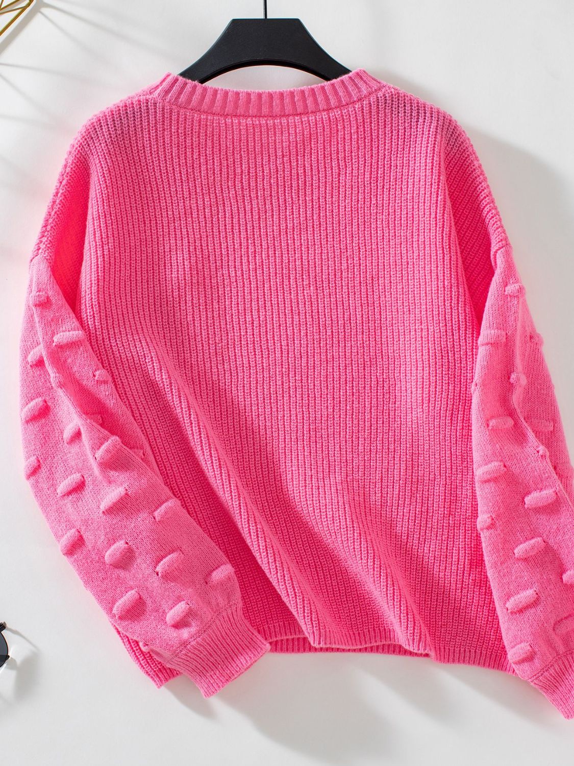 Hot Pink knit sweater with textured sleeve details and ribbed cuffs.