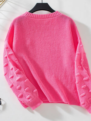 Hot Pink knit sweater with textured sleeve details and ribbed cuffs.