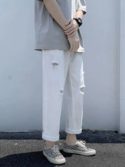 White relaxed fit men's jeans with distressed details and cuffed hem