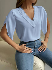 Light blue polyester blouse with lace trim neckline and cape sleeves